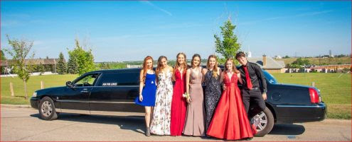 Graduation photo in front of black Lincoln Stretch Limousine